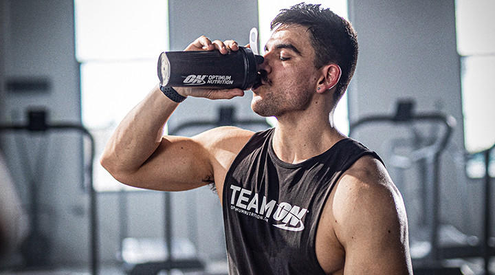 Athlete drinking ON product from shaker post workout