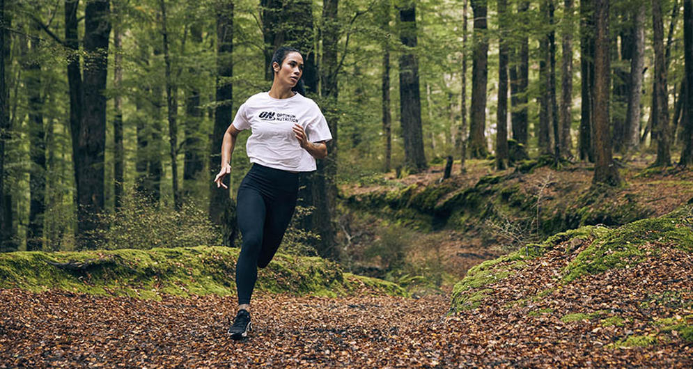 Girl running through wooded area