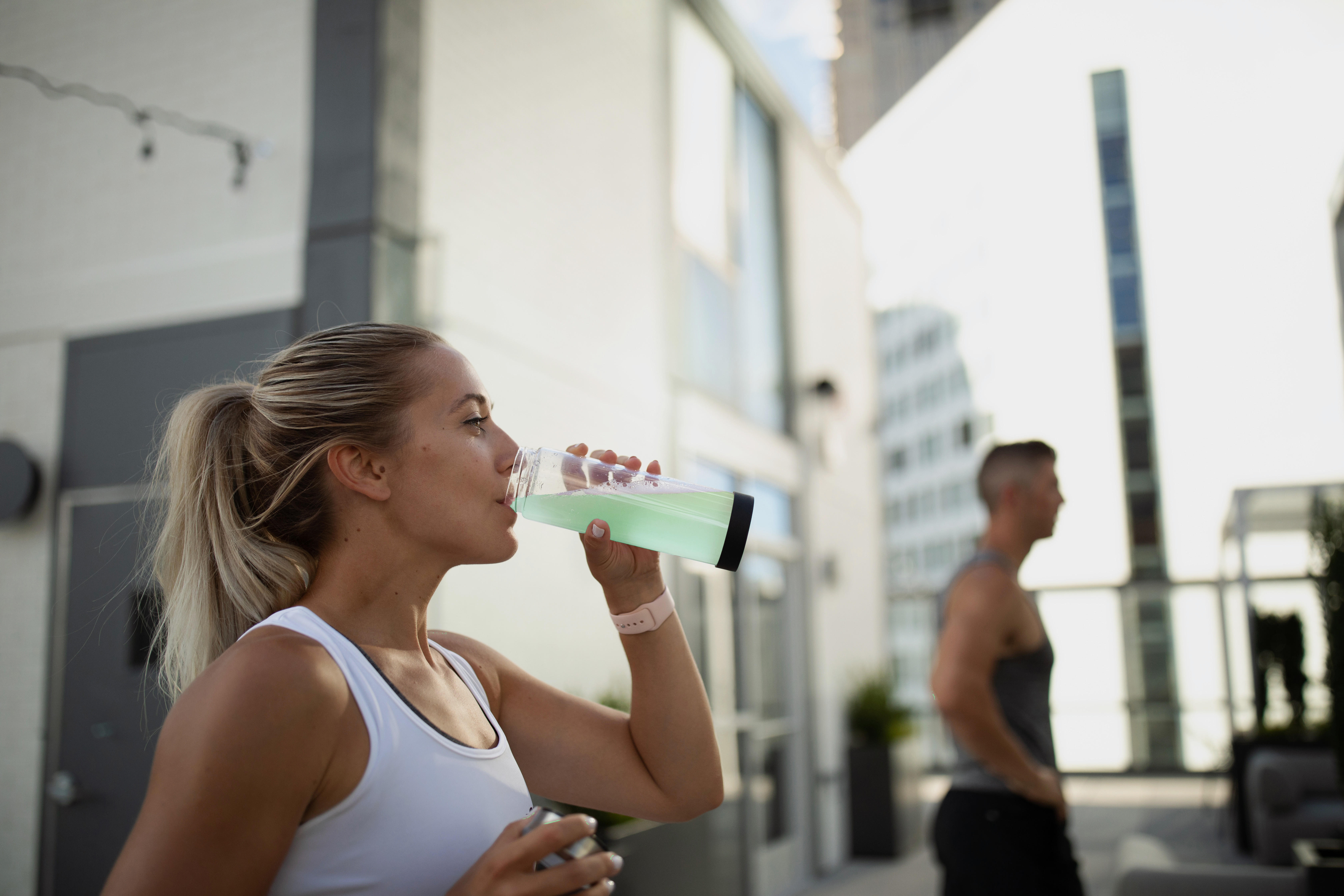 Athlete drinking Optimum Nutrition product during workout